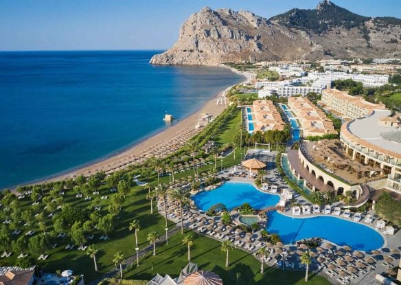 Aerial view of a beachside resort near the mountain