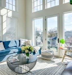 Spacious, white living room with high ceilings and natural light