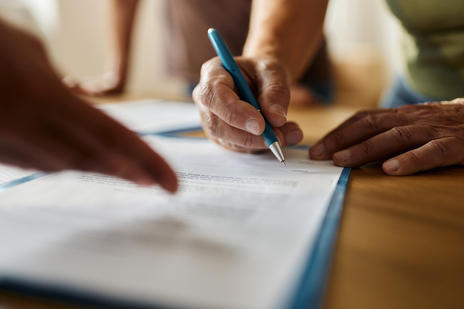 Paper being signed on desk