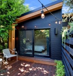 patio with chairs and string lights outside modern home