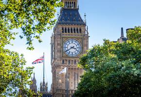 Phot of Elizabeth Tower and UK flag in the background on Houses of Parliament 