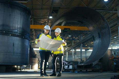 Workers looking at documents on a worksite