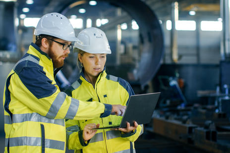 Workers looking at documents on a worksite