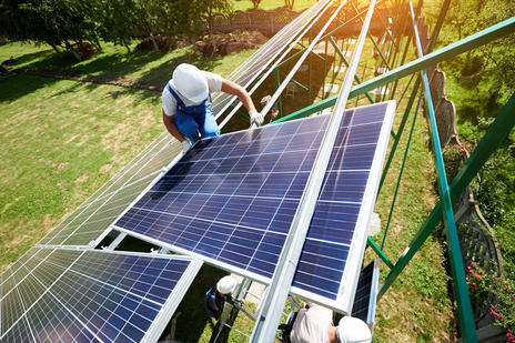 worker on solar panels