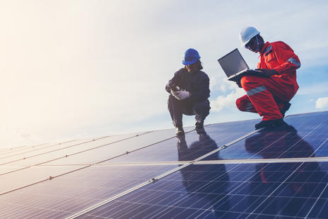 workers installing solar panels