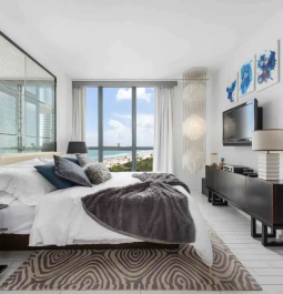 bedroom with windows overlooking the ocean