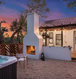 Outdoor fire place and hot tub in yard