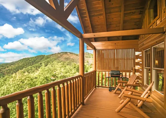 covered porch with gas grill and chairs at mountaintop cabin