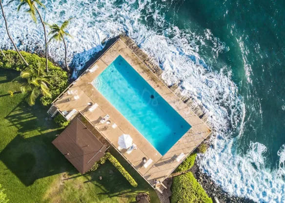 Pool at rental home that juts out into the ocean